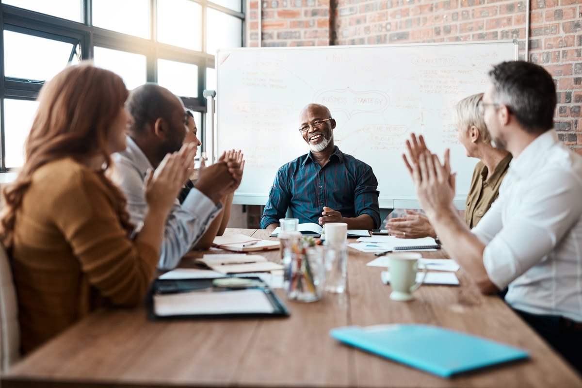 A team applauding at the end of a leadership session